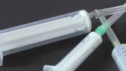 Closeup of syringes on black background Stock Footage 77536406