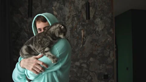 Closeup Tabby Cat With Man Peeking Over Shoulder 動画素材 335950480