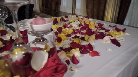 Closeup of table decorated with rose petals in the restaurant Stock Footage 73516366