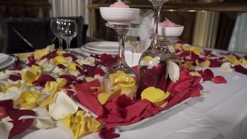 Closeup of table with rose petals in the restaurant Stock Footage 73516317