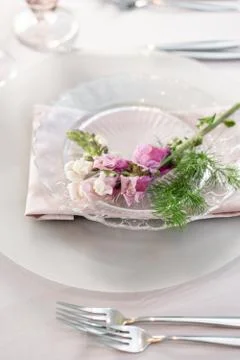 Closeup Table setting with plates and tableware, adorned with flowers. Floral Stock Photos