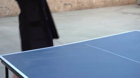 Closeup of a table tennis game of a white woman in dress and jacket winning in a Vidéo 161954031