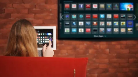 Closeup of a tablet is connected to a smart TV. Stock Footage 72955573