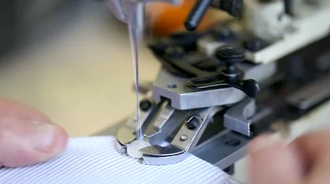 Closeup of tailor sewing buttons on a made to measure shirt. Stock Footage