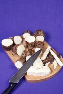 Closeup of taro root vegetable, eddo malanga, purple background Stock Photos