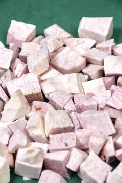 Closeup of taro root vegetable, eddo malanga, green background Stock Photos