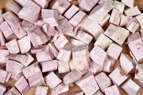 Closeup of taro root vegetable, eddo malanga, green background Stock Photos