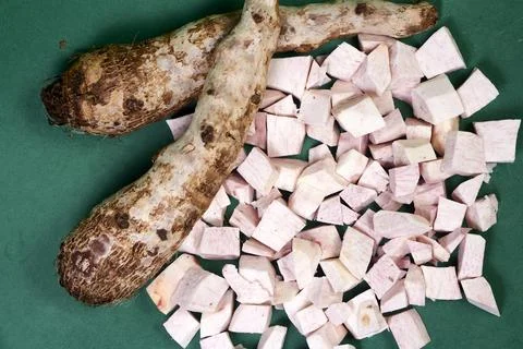 Closeup of taro root vegetable, eddo malanga, green background Stock Photos