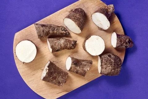 Closeup of taro root vegetable, eddo malanga, purple background Stock Photos