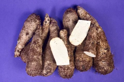 Closeup of taro root vegetable, eddo malanga, purple background Foto stock