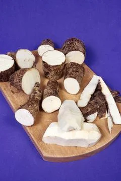 Closeup of taro root vegetable, eddo malanga, purple background Stock Photos