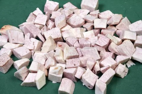 Closeup of taro root vegetable, eddo malanga, green background Stock Photos