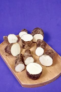 Closeup of taro root vegetable, eddo malanga, purple background Stock Photos