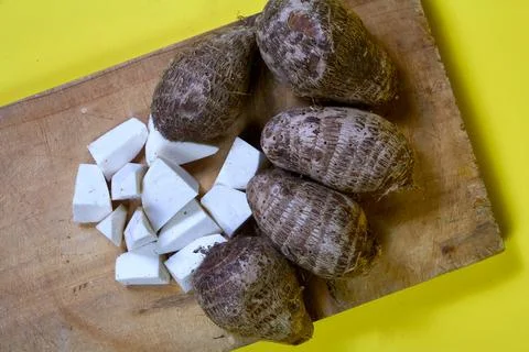 Closeup of taro root vegetable, eddo malanga, yellow background Foto stock