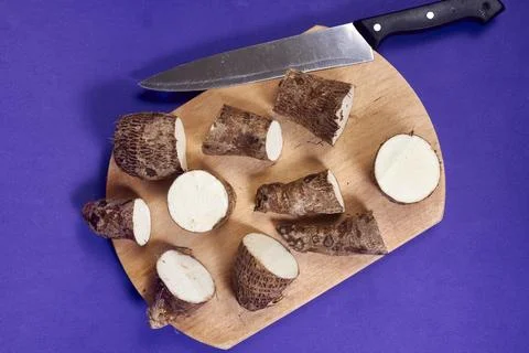 Closeup of taro root vegetable, eddo malanga, purple background Stock Photos