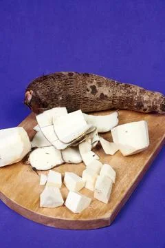 Closeup of taro root vegetable, eddo malanga, purple background Stock Photos