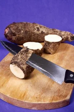 Closeup of taro root vegetable, eddo malanga, purple background Stock Photos