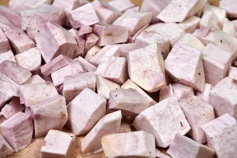 Closeup of taro root vegetable, eddo malanga, green background Stock Photos