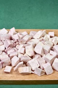 Closeup of taro root vegetable, eddo malanga, green background Stock Photos