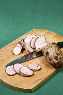 Closeup of taro root vegetable, eddo malanga, green background Stock Photos