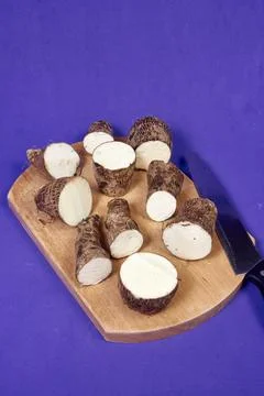 Closeup of taro root vegetable, eddo malanga, purple background Stock Photos