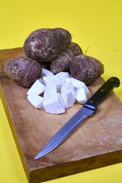 Closeup of taro root vegetable, eddo malanga, yellow background Foto stock