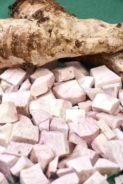 Closeup of taro root vegetable, eddo malanga, green background Stock Photos