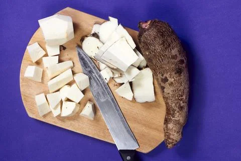 Closeup of taro root vegetable, eddo malanga, purple background Stock Photos