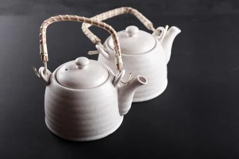 Closeup of tea set on black background. Stock Photos