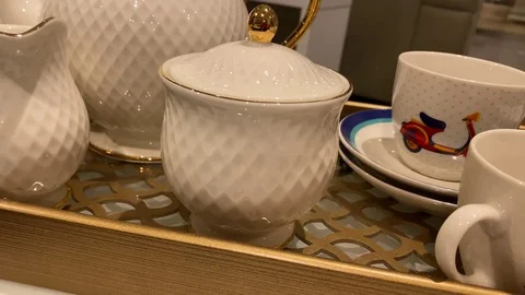 Closeup of Teapot, tea set and cups kept on a table Stock Footage 125966827