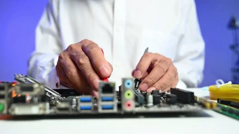 Closeup of technician testing a computer motherboard using tools and gloves.. Stock Footage 312773614