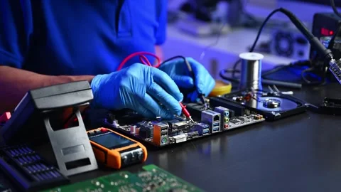 Closeup of technician testing a computer motherboard using tools and gloves.. Stock Footage 312774021