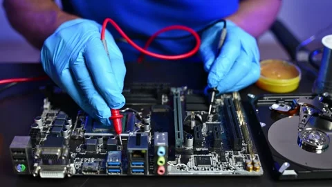 Closeup of technician testing a computer motherboard using tools and gloves.. Stock Footage 312774034