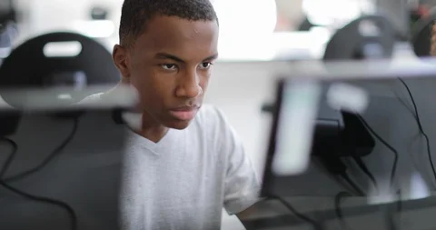 Closeup teenage boy using a computer in class Stock Footage 93156307