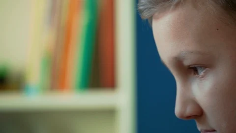 Closeup of teenager looking to computer screen, trucking right Stock Footage 123160783