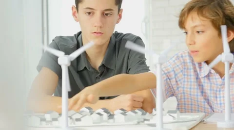 Closeup of teens at school learning about wind power Stock Footage 59763371
