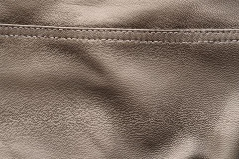 Closeup texture full grain gray brown leather with seam Stock Photos