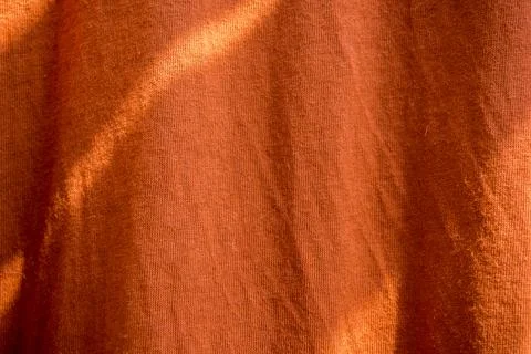 Closeup texture of orange fabric with soft lighting and natural folds 스톡 사진