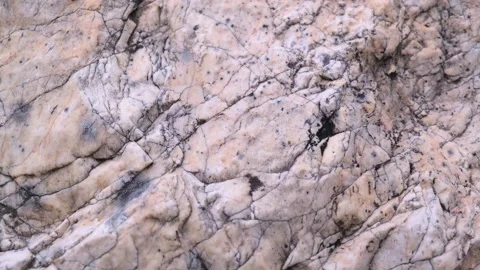 Closeup of texture of raw stone with cracks and irregularities. selective focus. Stock Footage 229835456