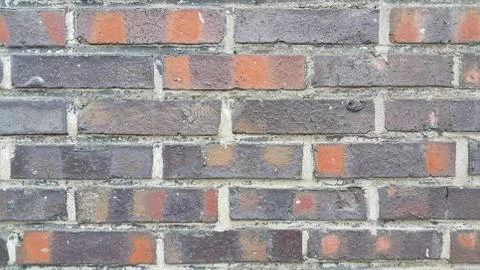 Closeup texture of red brick wall. A background of a weathered old exterior b Stock Photos