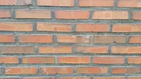 Closeup texture of red brick wall. A background of a weathered old exterior b Stock Photos