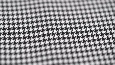 Closeup of texture of tweed fabric houndstooth, classic woolen pattern, rotating Stock Footage 252910820