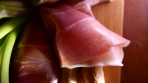 Closeup of thin slices of pork ham on the dish with cheese and greens. 4K UHD 動画素材 73047387