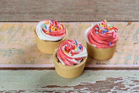 Closeup of three mini sable pastry pies with whipped cream topping. Stock Photos