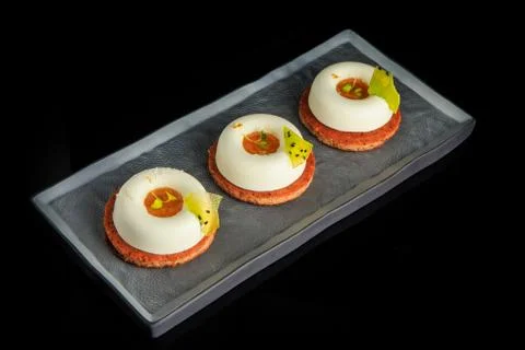 Closeup three mini white mousse cakes with jam filling Fotos de archivo