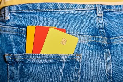 Closeup of three multicolored microchip credit cards protruding from the ba.. Stock Photos