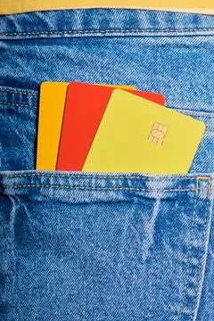 Closeup of three multicolored microchip credit cards protruding from the ba.. Stock Photos