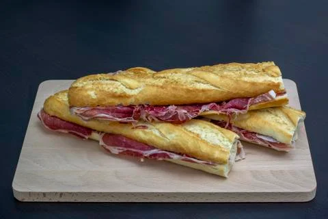 Closeup of three  spanish iberic ham sandwich served in a wooden plate Stock Photos