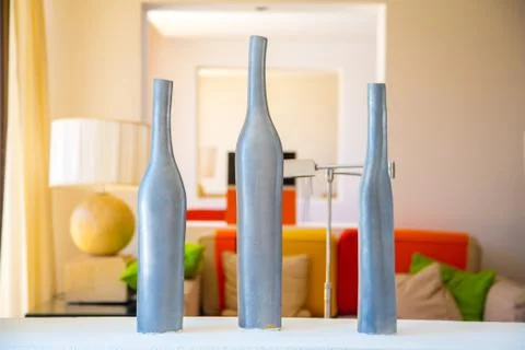 Closeup of three stylish vases on a table in a room of a luxury hotel Stock Photos