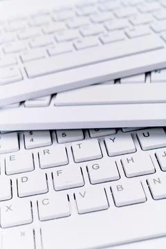 Closeup of three white computer keyboards with a wireless connection Stock Photos